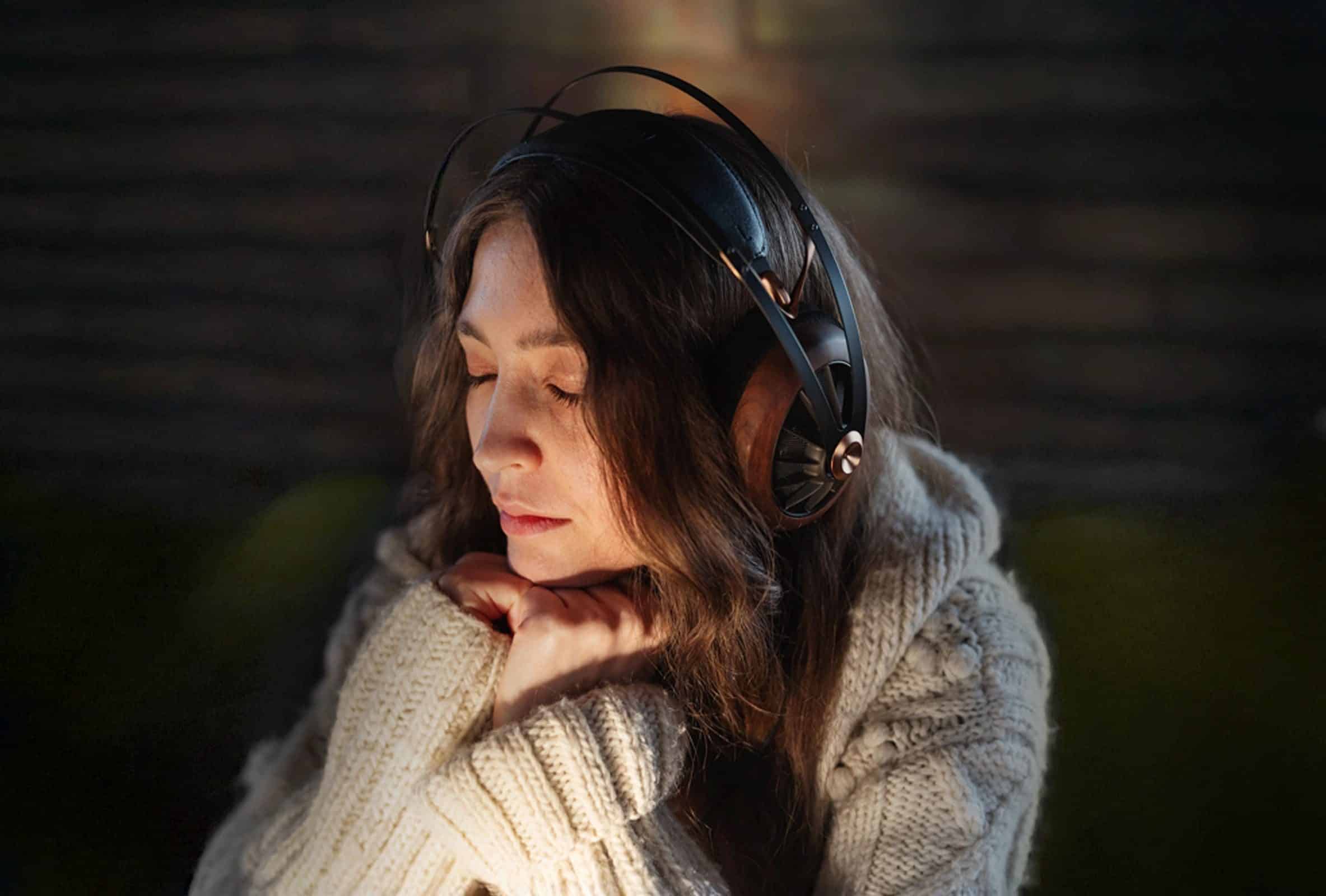 Mujer joven escuchando unos auriculares premium Meze Audio 109 PRO con controlador dinámico y de respaldo abierto
